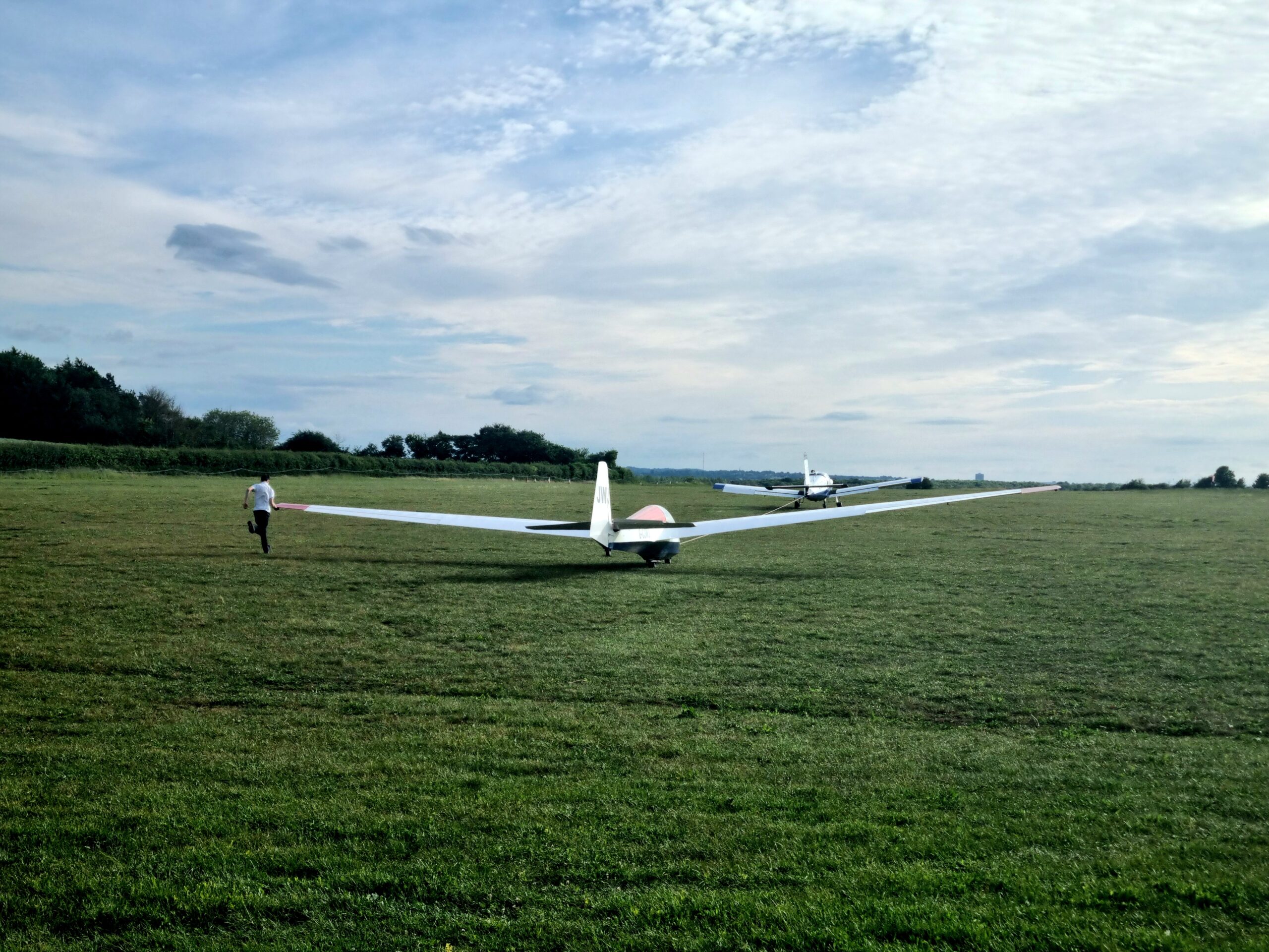 Running the wing as the glider starts to roll behind the tow-plane